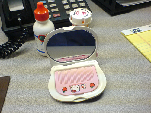  a proud Hello-Kitty-Mirror-Compact-With-Built-In-Comb-Carrying citizen.